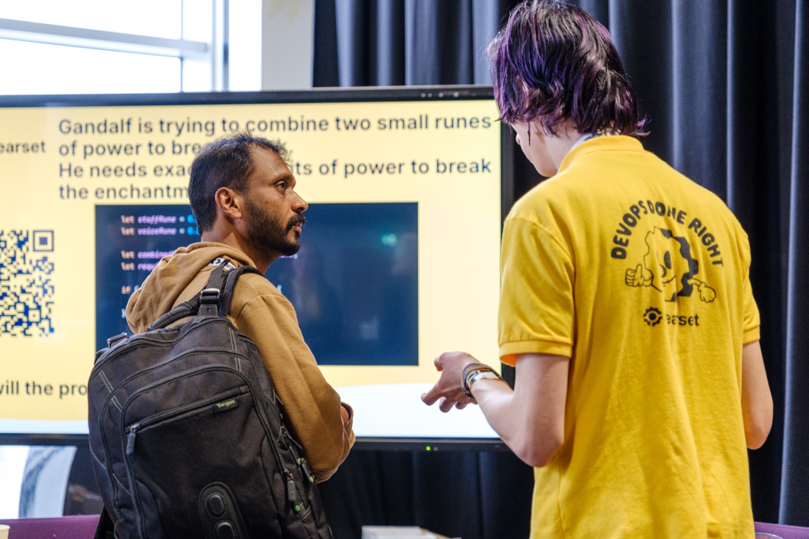 Attendees chatting at a village stand at NIDC 2025